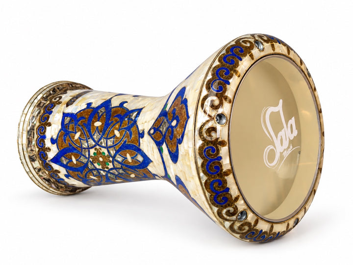 Sala Azure Arabesque Sombaty darbuka on its side, showing the Sala-branded drumhead and cobalt-blue and gold-toned floral mosaic on an ivory background.