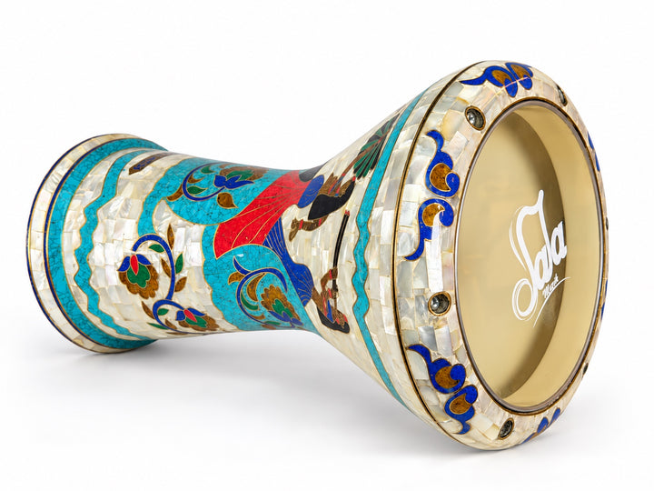 Sala Nile Muse Sombaty darbuka on its side, showing the Sala-branded drumhead and Egyptian-inspired figures, turquoise borders and colorful floral scrolls.